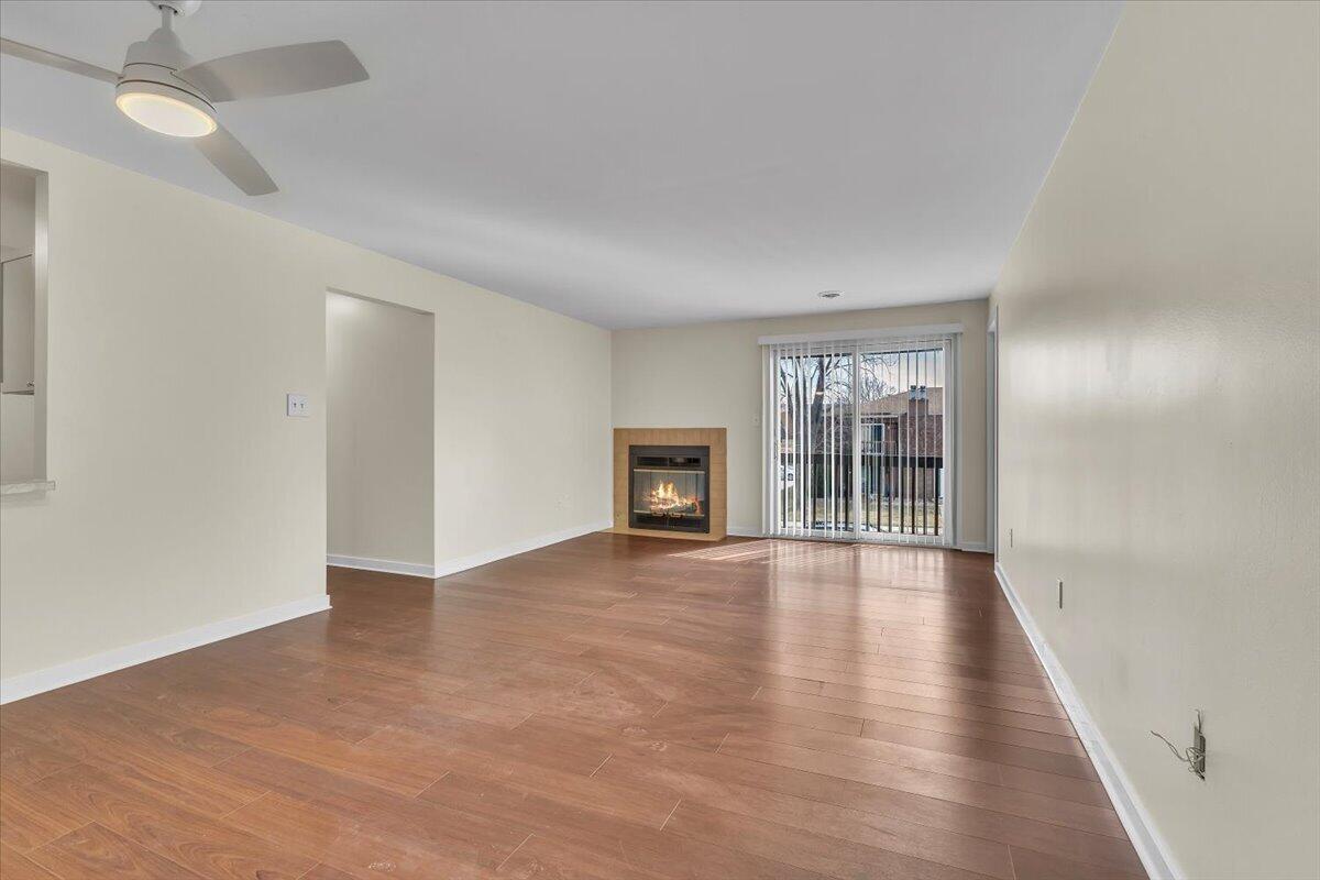 1444 Woodview Drive, Unit 7 Crown Point, IN 46307 - Photo 3 of 15 a view of an empty room with wooden floor and a window
