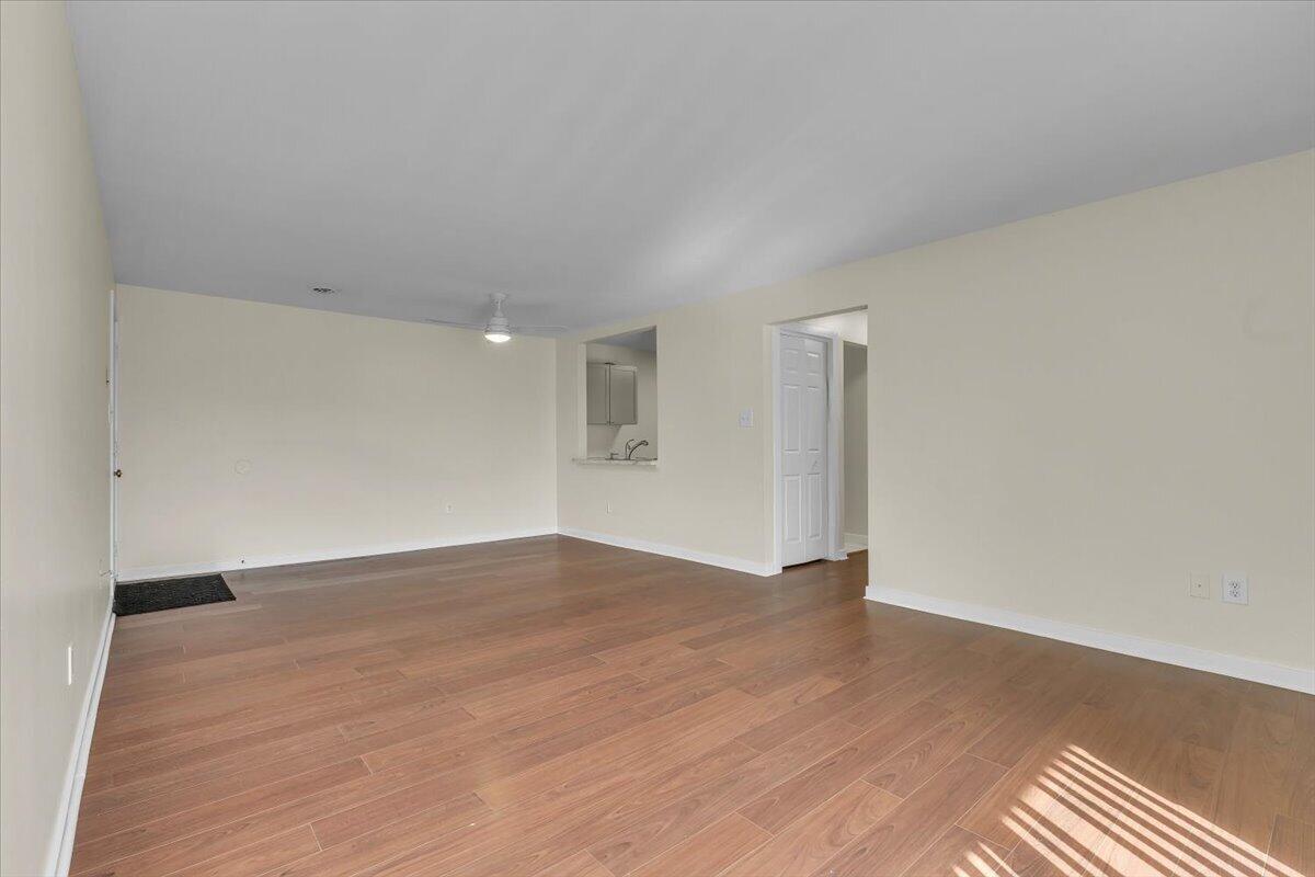 1444 Woodview Drive, Unit 7 Crown Point, IN 46307 - Photo 6 of 15 a view of an empty room with wooden floor and a window
