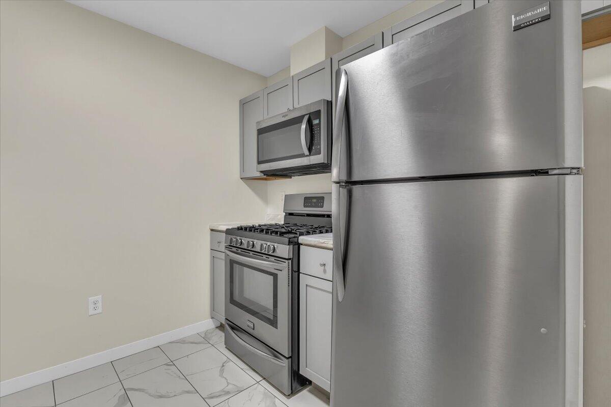1444 Woodview Drive, Unit 7 Crown Point, IN 46307 - Photo 8 of 15 a white refrigerator freezer and a stove sitting inside of a kitchen