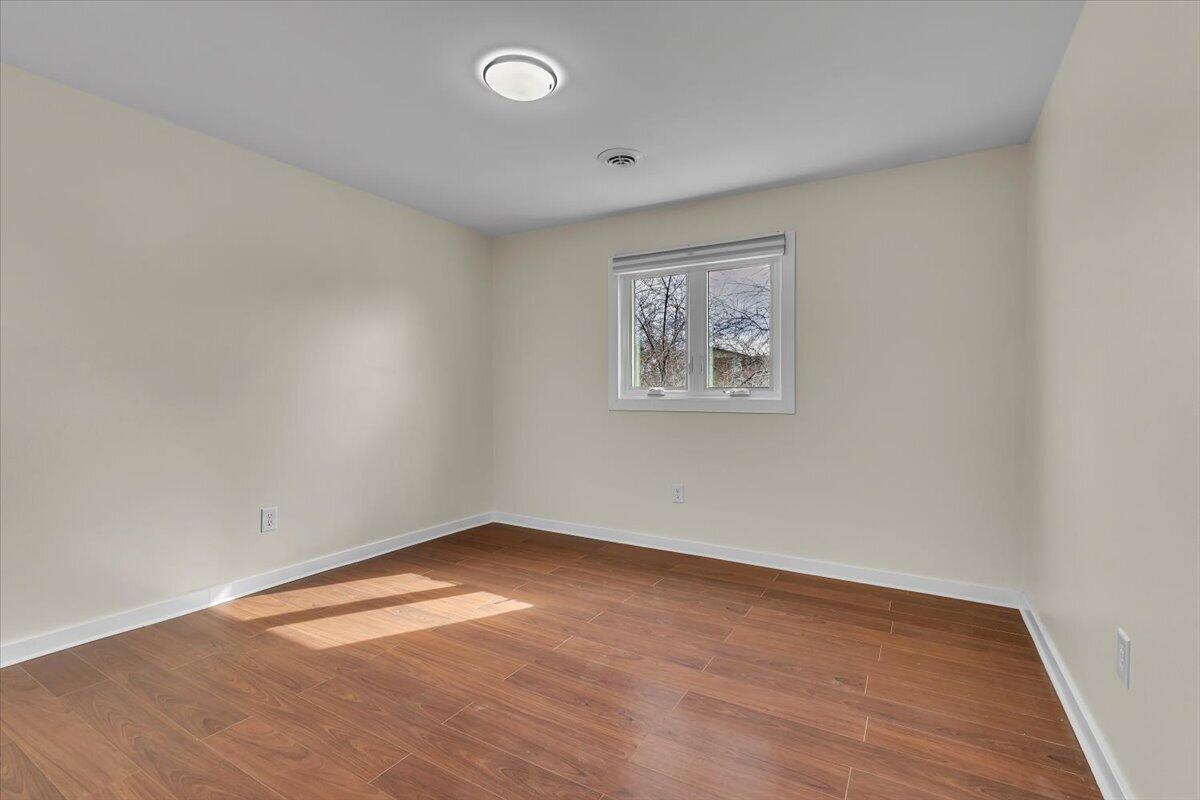 1444 Woodview Drive, Unit 7 Crown Point, IN 46307 - Photo 10 of 15 an empty room with a wooden floor and window