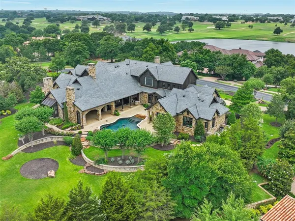 an aerial view of a house with garden space and street view