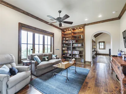 a living room with furniture a rug and a large window