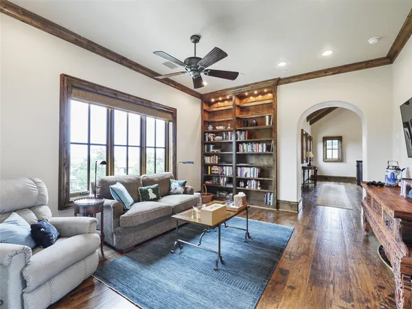 a living room with furniture a rug and a large window