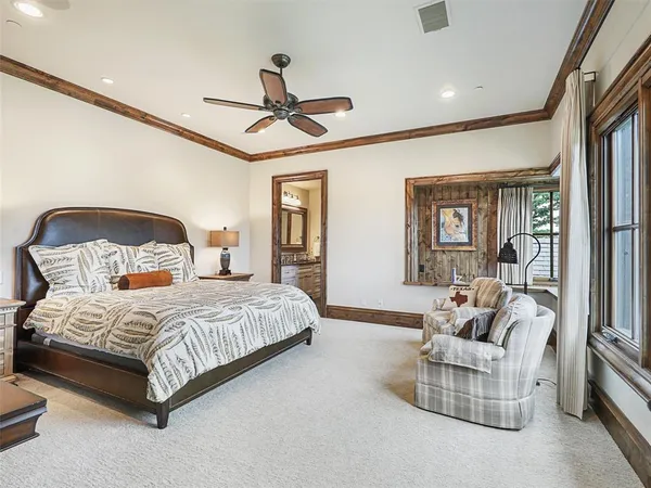 a bedroom with a bed couch and window