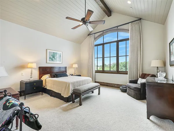 a bedroom with a bed couch and a window
