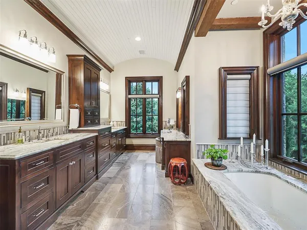 a large spacious bathroom with a large tub and sink