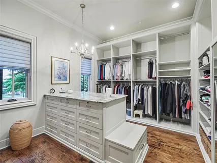 a living room with lots of wooden furniture and a window