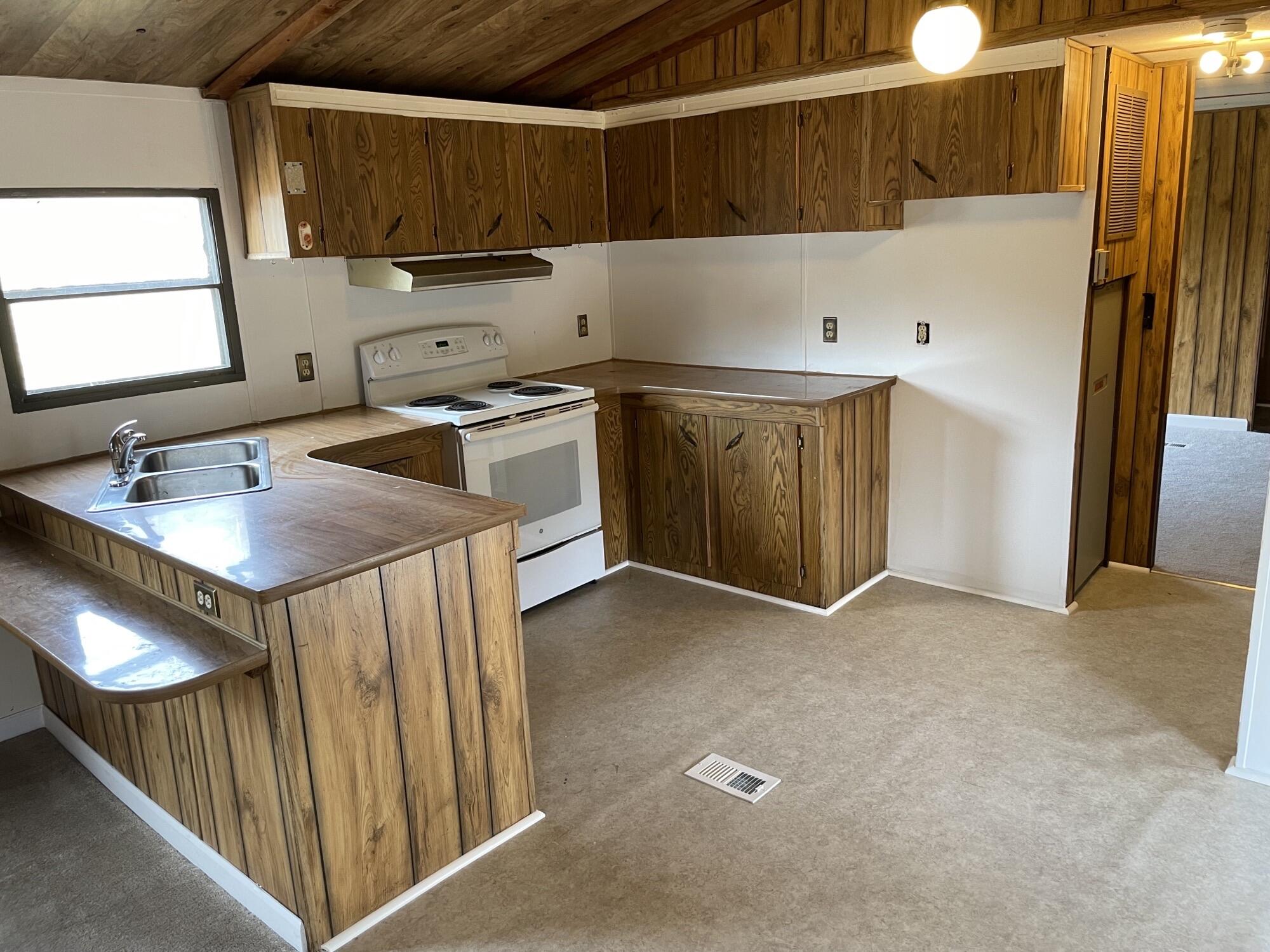 3163 North Fork Road Elliston, VA 24087 - Photo 2 of 10 a kitchen with a sink stove and cabinets