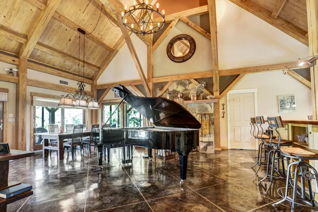 a view of a livingroom with furniture wooden floor and a floor to ceiling window