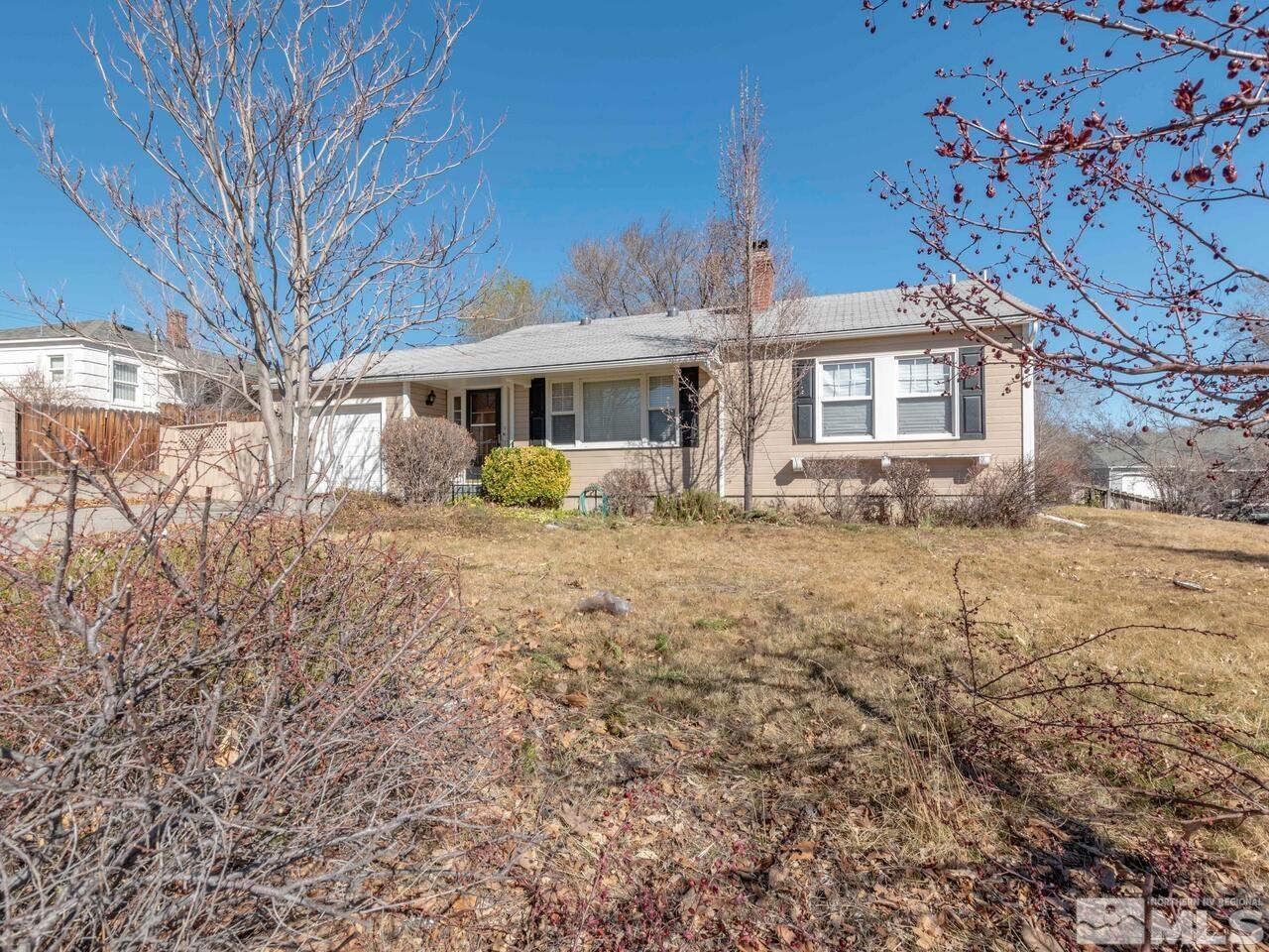 1061 Whitaker Drive Reno, NV 89503 - Photo 1 of 20 a front view of a house with a yard