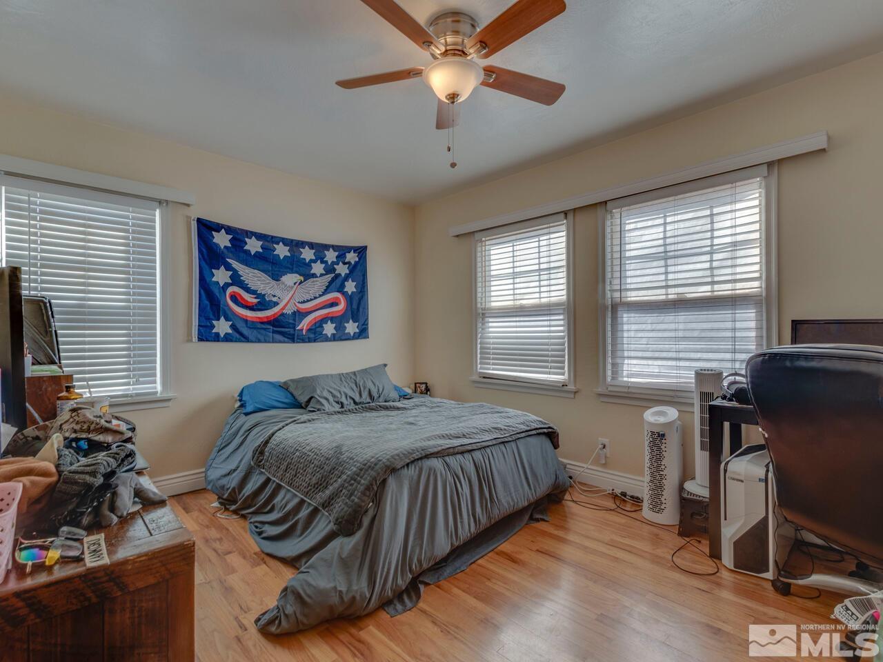 1061 Whitaker Drive Reno, NV 89503 - Photo 12 of 20 a bedroom with a bed and a chandelier