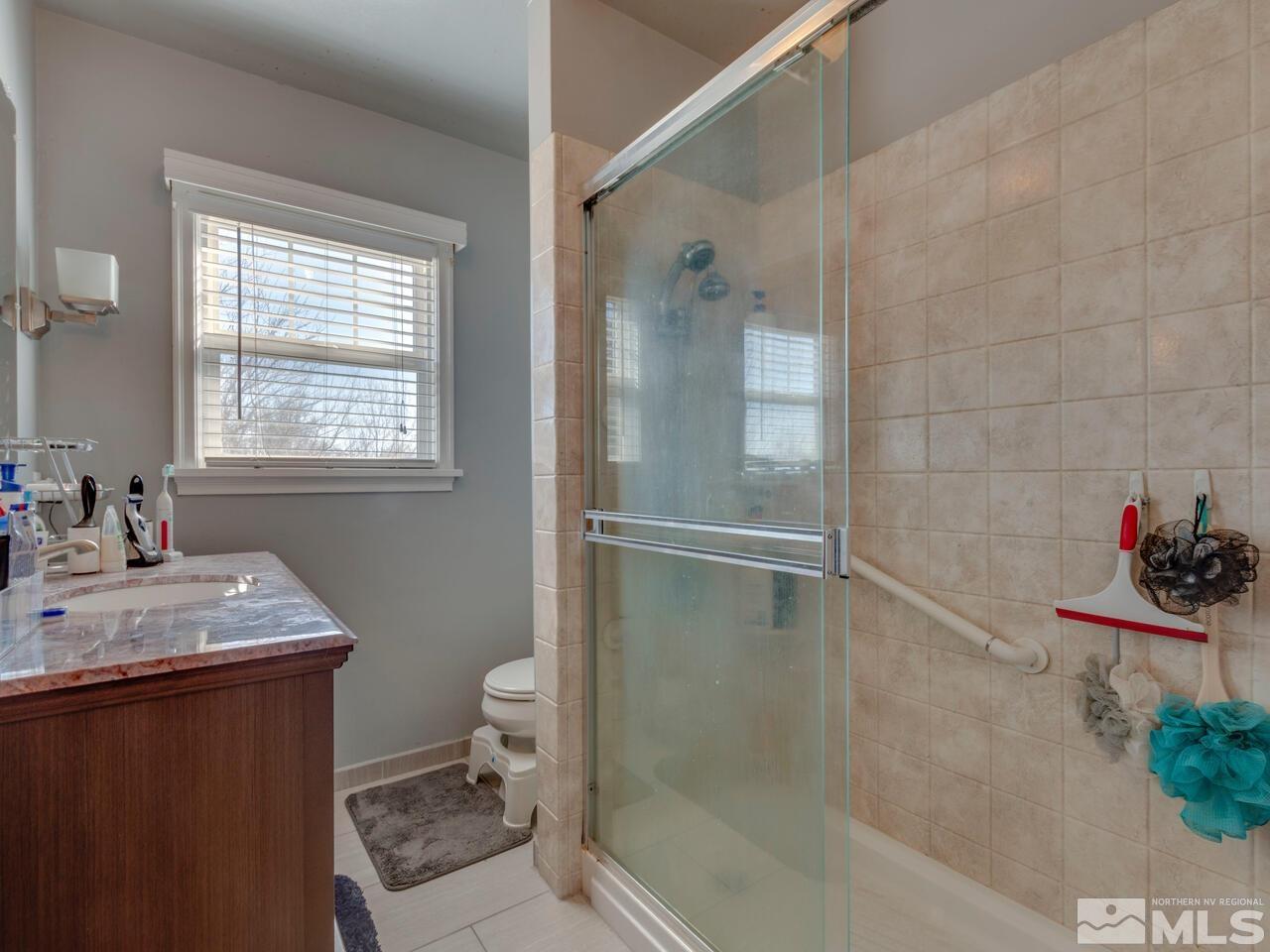 1061 Whitaker Drive Reno, NV 89503 - Photo 13 of 20 a bathroom with a sink toilet and shower