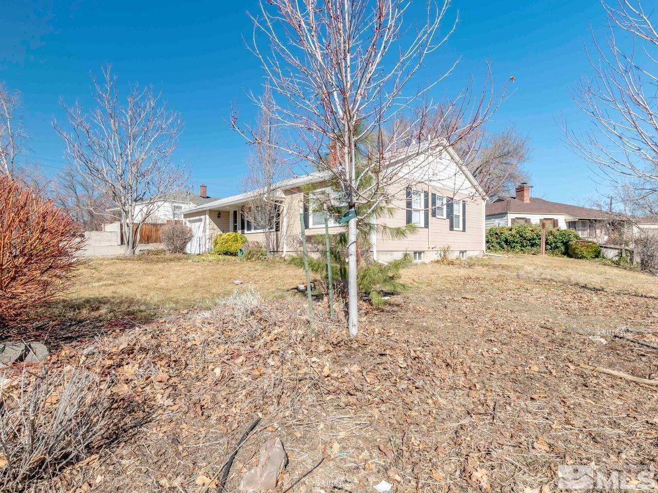 1061 Whitaker Drive Reno, NV 89503 - Photo 3 of 20 a front view of a house with a yard