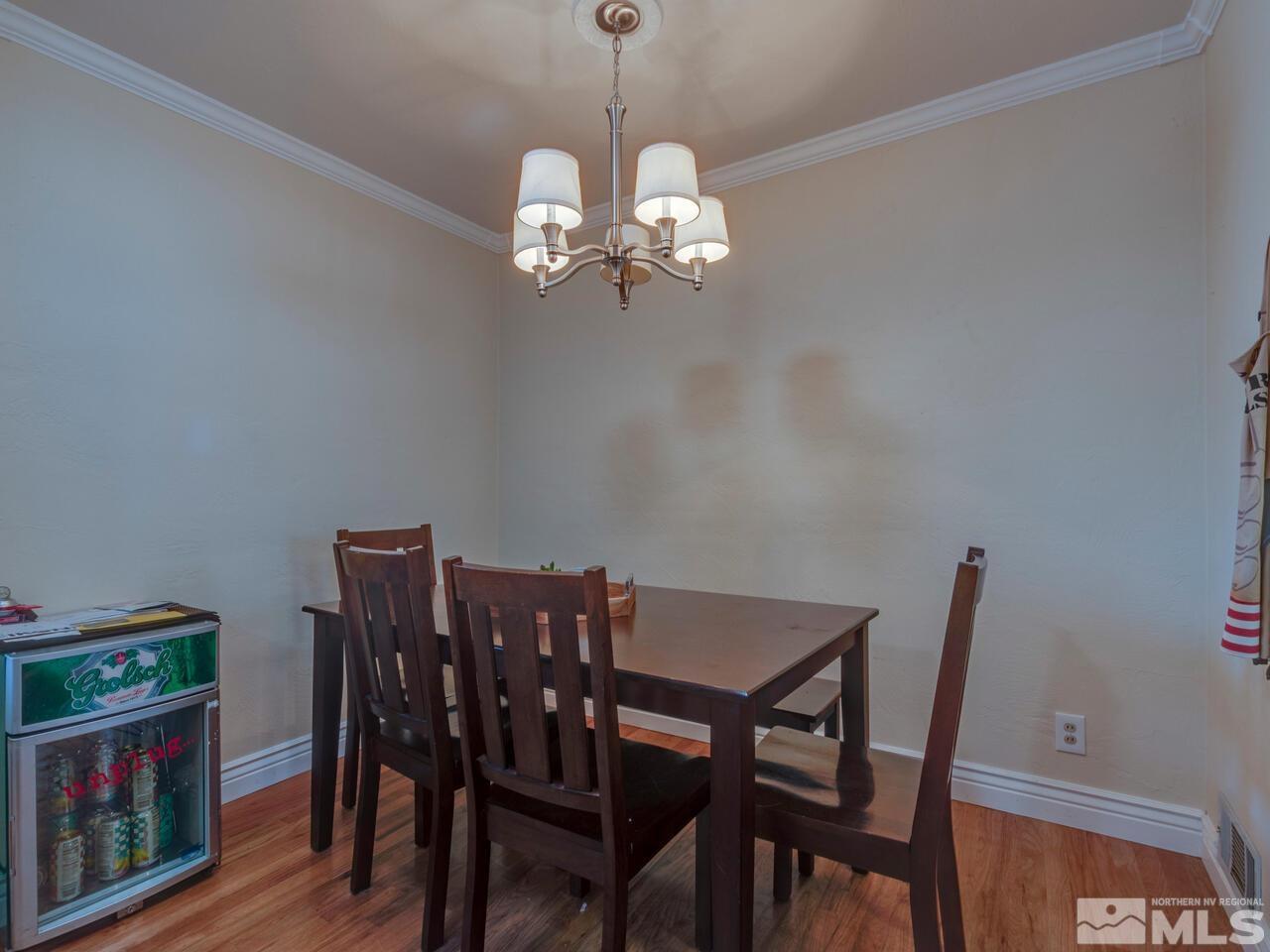 1061 Whitaker Drive Reno, NV 89503 - Photo 7 of 20 a view of a dining room with furniture wooden floor and a chandelier