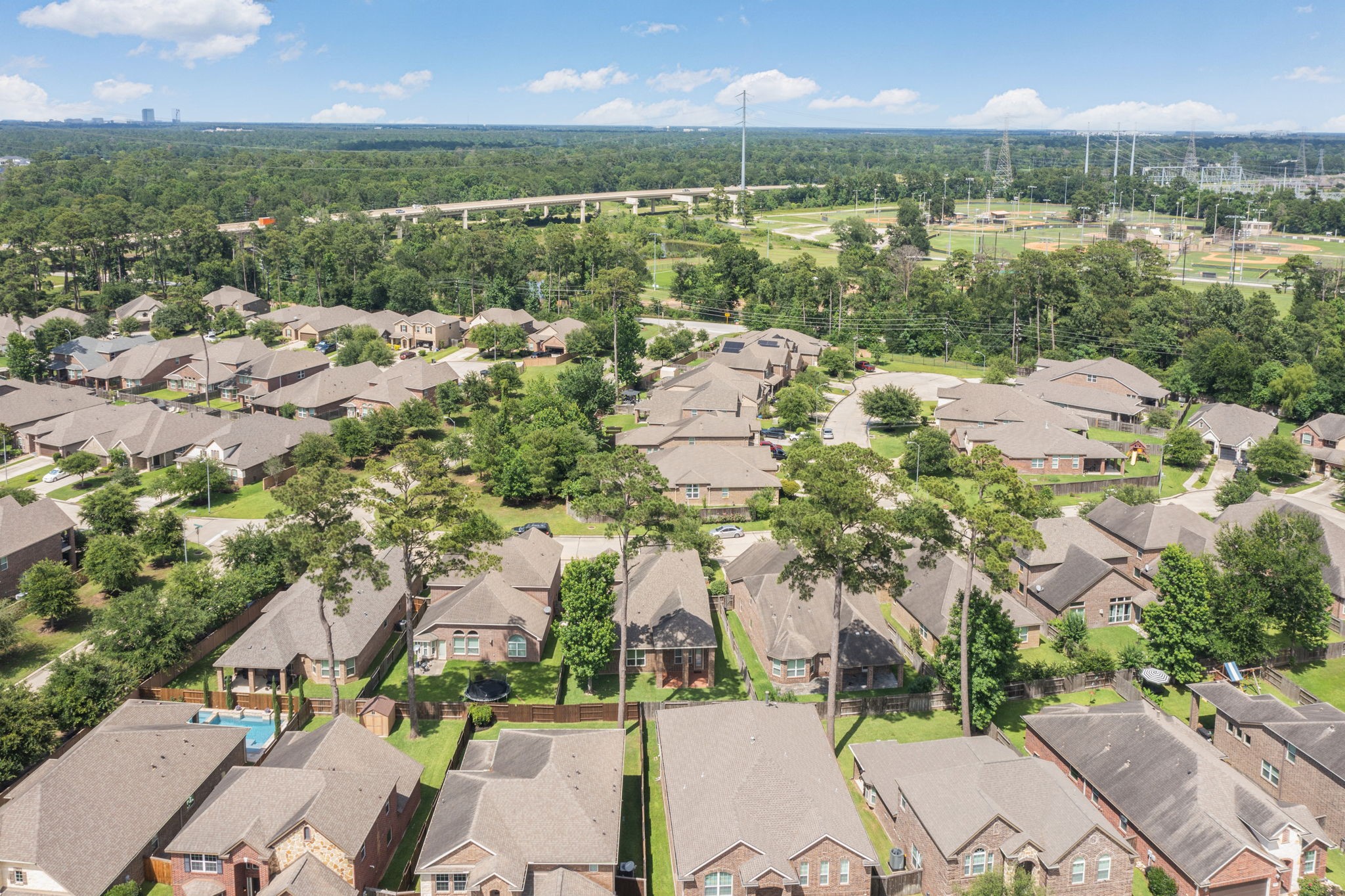 22523 Birch Ridge Meadow Drive Spring, TX 77389 - Photo 38 of 39 an aerial view of residential houses with outdoor space and river