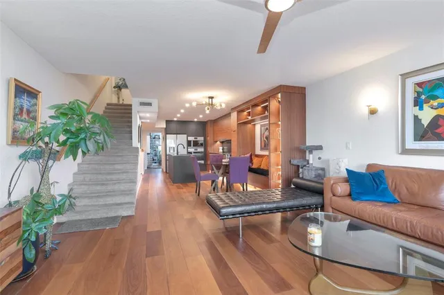 a living room with furniture and wooden floor