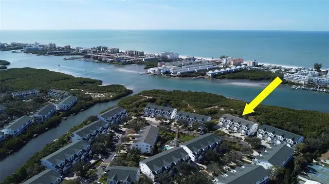 an aerial view of a houses with ocean view