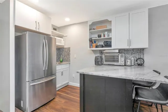 a view of a kitchen filled with furniture and workspace