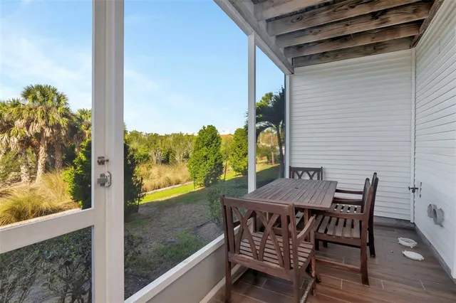 a view of a balcony with table and chairs and wooden floor