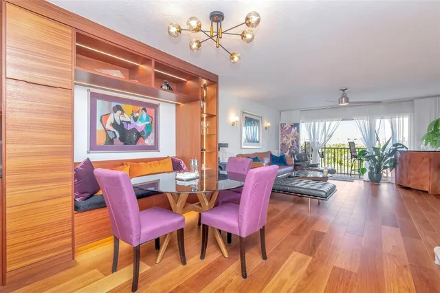 a living room with furniture a couch and a painting on the wall