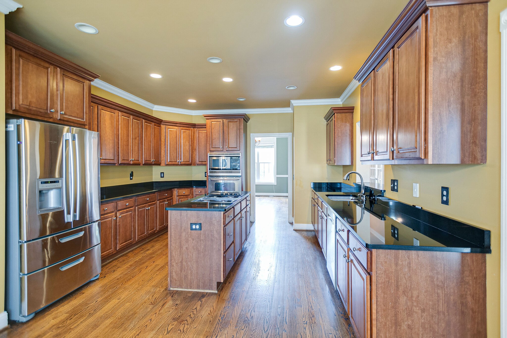 1613 Fair House Road Spring Hill, TN 37174 - Photo 13 of 26 a kitchen with stainless steel appliances granite countertop a refrigerator a sink dishwasher a stove and a oven with wooden floor