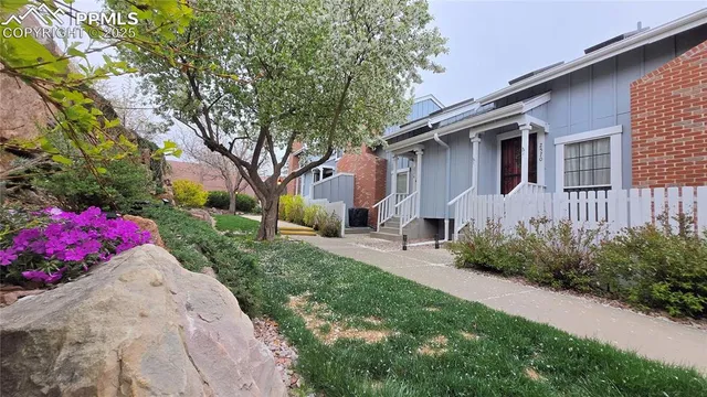 a front view of a house with yard and outdoor seating
