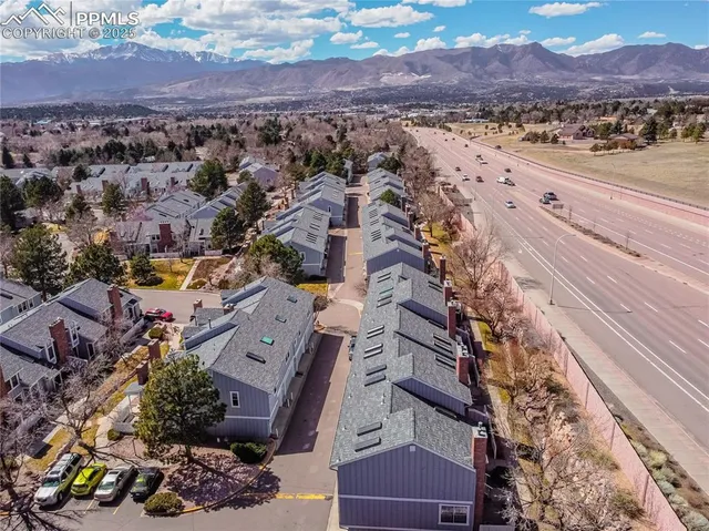 an aerial view of residential houses with outdoor space