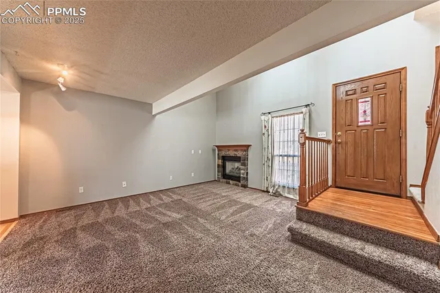 a view of a livingroom with entryway and stairs