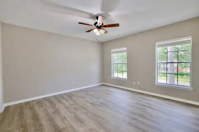 wooden floor in an empty room with a window