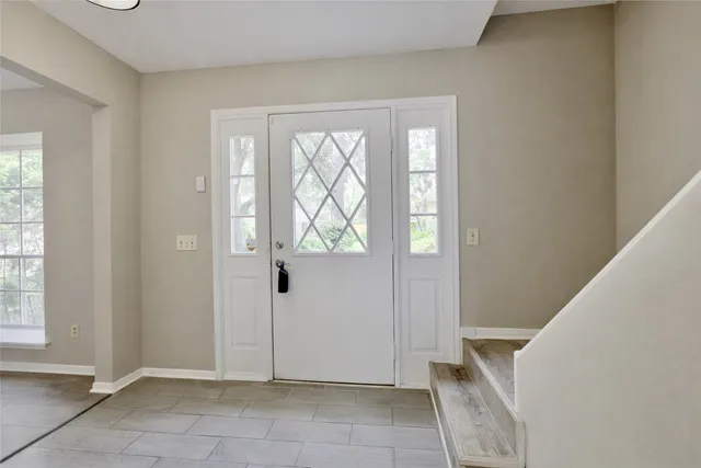 a view of an entryway with wooden floor