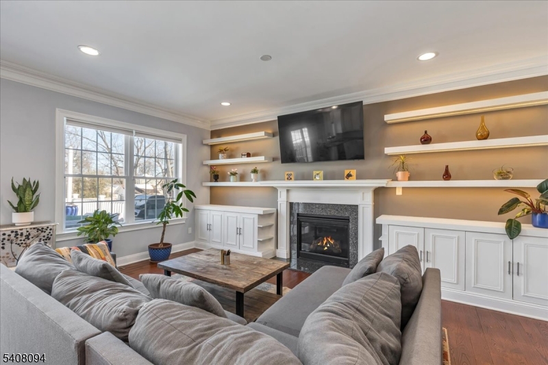 177 Maple Street Bridgewater, NJ 08807 - Photo 8 of 37 a living room with furniture a fireplace and a flat screen tv