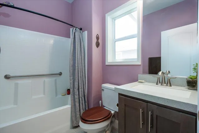 a bathroom with a sink a toilet a shower and a mirror