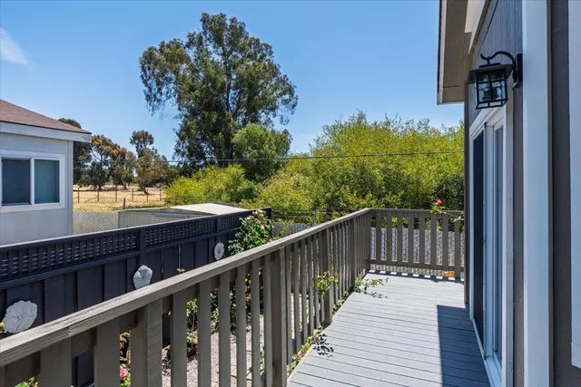 a balcony with wooden floor and outdoor space
