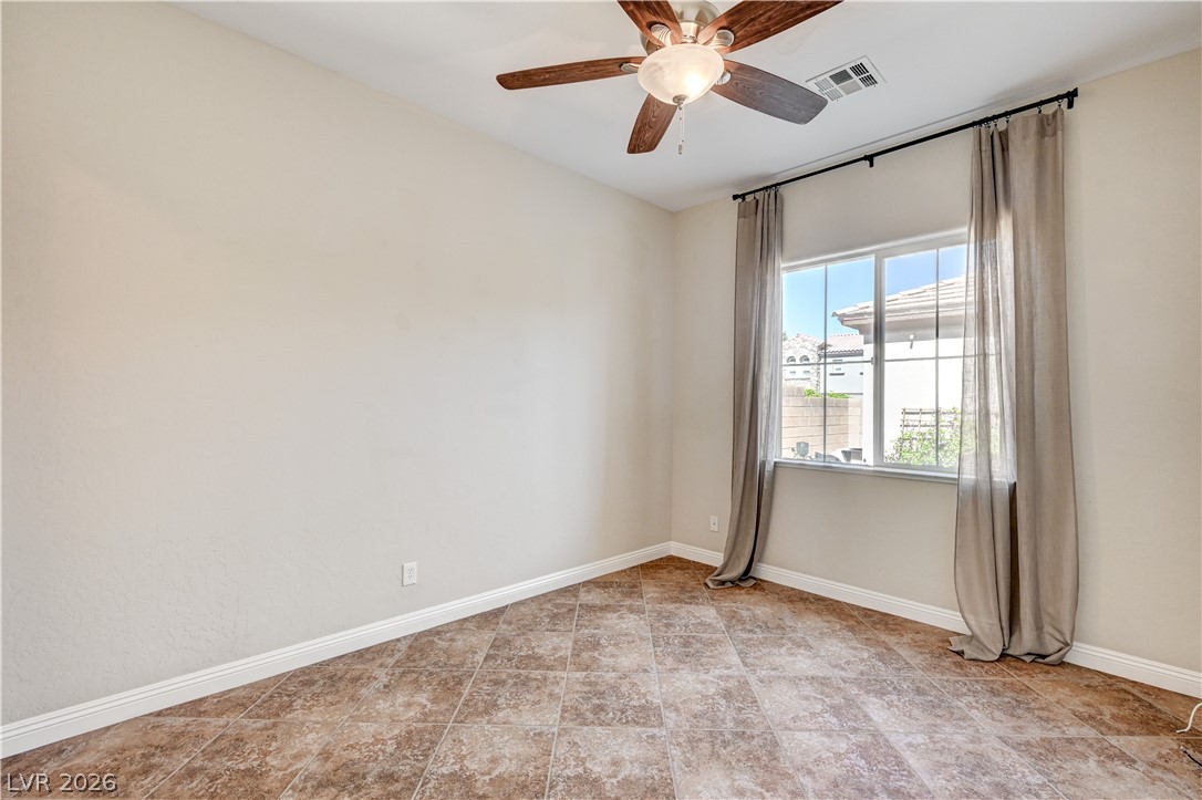 2793 Rosenhearty Drive Henderson, NV 89044 - Photo 29 of 85 This naturally illuminated room features durable tile flooring, a large window, and a ceiling fan for optimal comfort.