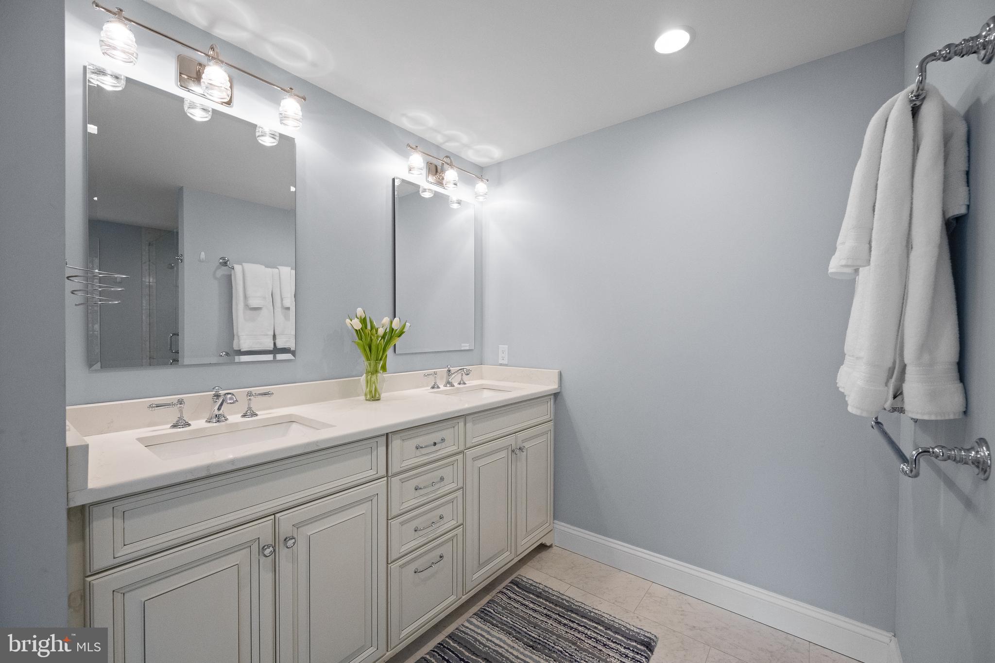 115 Barcladen Road Bryn Mawr, PA 19010 - Photo 31 of 39 a bathroom with a double vanity sink and a mirror