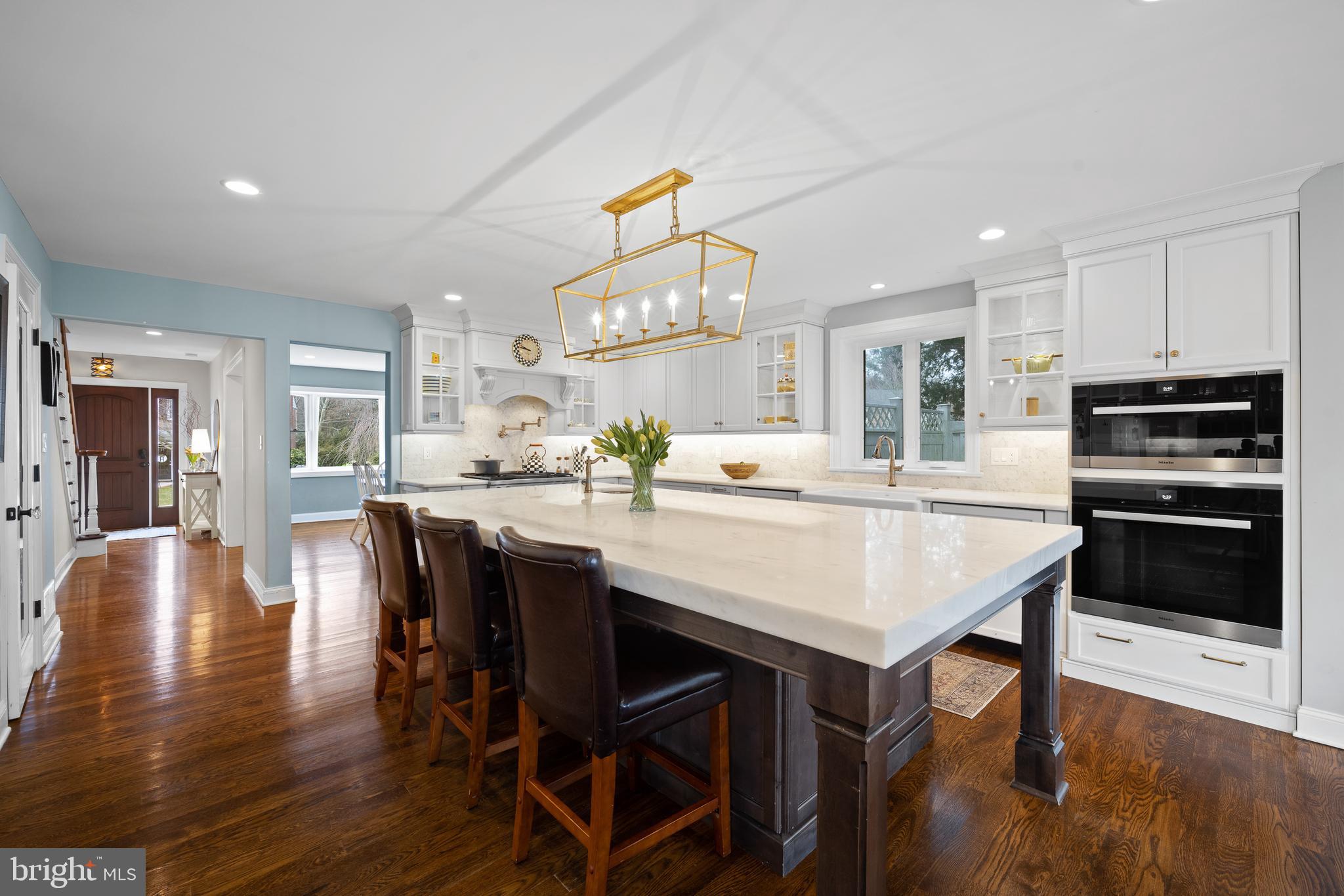 115 Barcladen Road Bryn Mawr, PA 19010 - Photo 5 of 39 a kitchen with stainless steel appliances kitchen island granite countertop a table chairs and a refrigerator