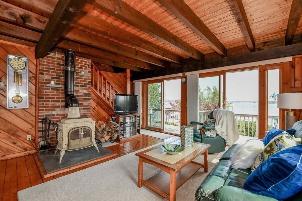 14 Sias Point Road Wareham, MA 02532 - Photo 19 of 42 a living room with furniture a fireplace and a roof next to a window