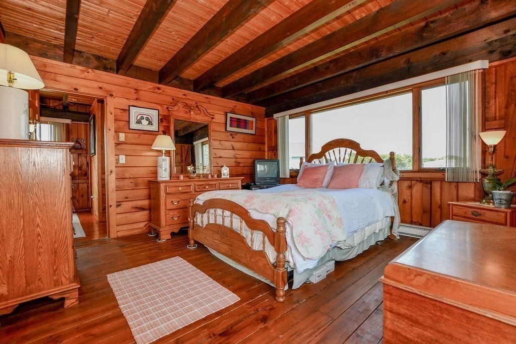 14 Sias Point Road Wareham, MA 02532 - Photo 24 of 42 a bedroom with a bed a dresser next to a window