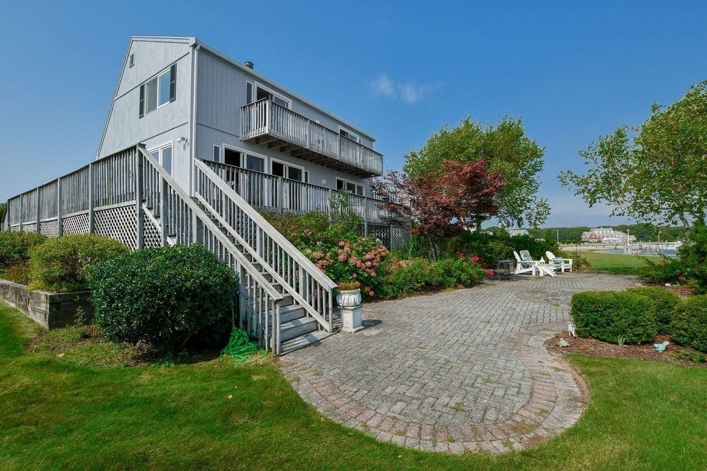 14 Sias Point Road Wareham, MA 02532 - Photo 5 of 42 a view of a house with brick walls and a yard with plants