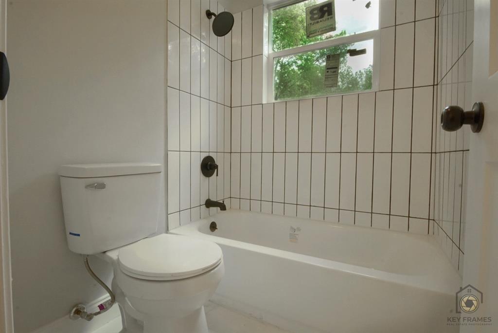 9227 Walker Road Shreveport, LA 71118 - Photo 13 of 16 a bathroom with a toilet and shower