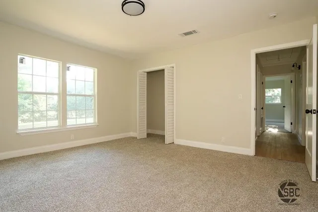 a view of an empty room with glass door