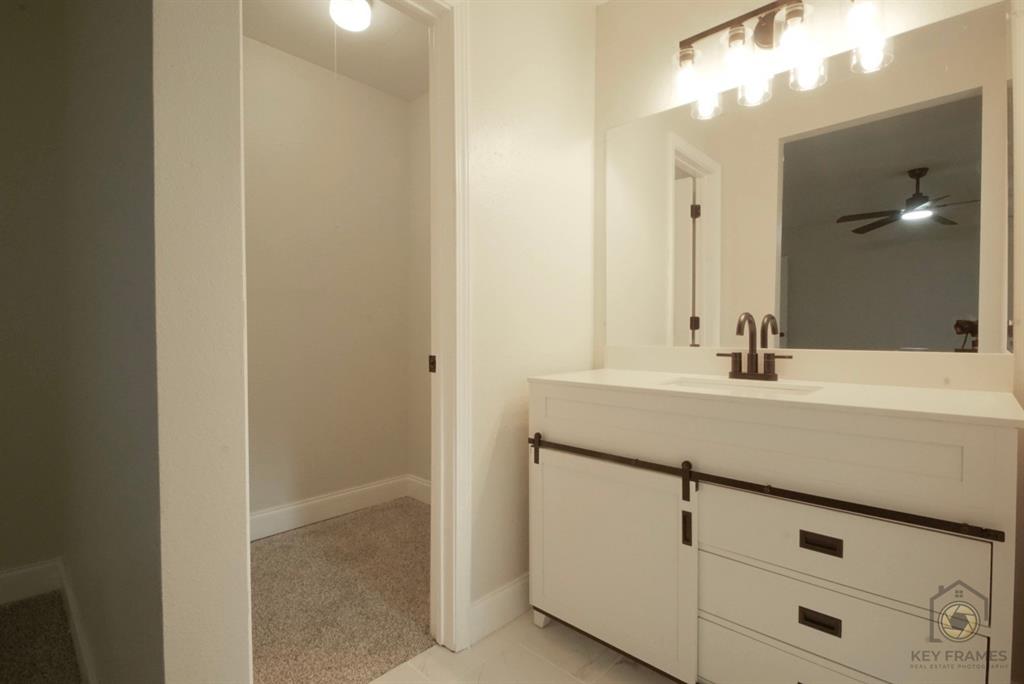 9227 Walker Road Shreveport, LA 71118 - Photo 15 of 16 a bathroom with a sink and a mirror