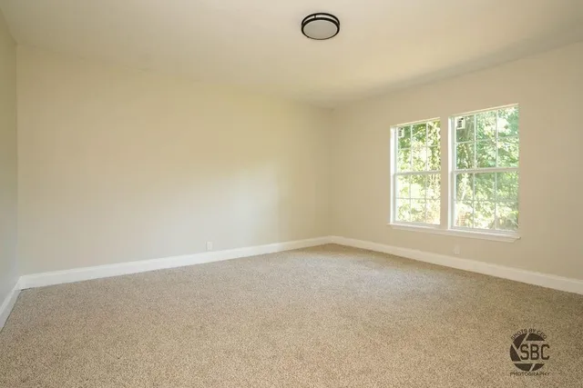 an empty room with a empty space and a window