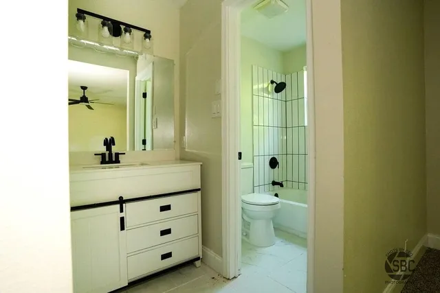a bathroom with a double vanity sink toilet and shower