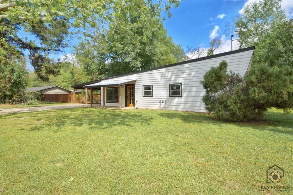 9227 Walker Road Shreveport, LA 71118 - Photo 2 of 16 a front view of house with yard and trees in the background