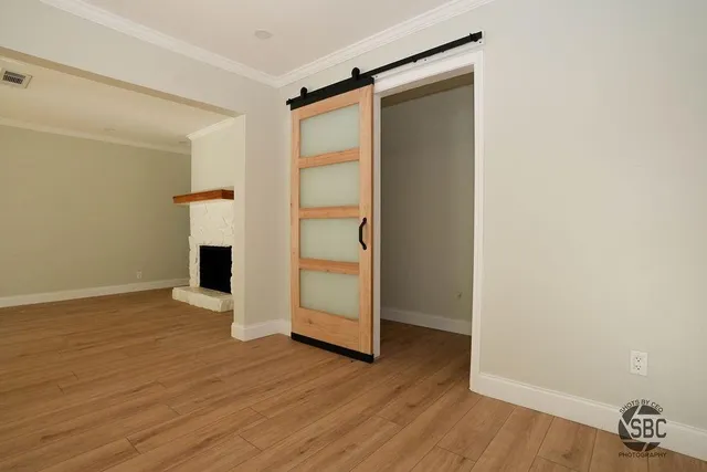 an empty room with wooden floor and closet