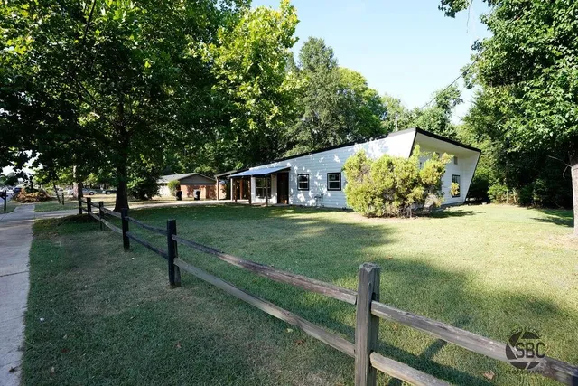 a view of a house with yard and a tree
