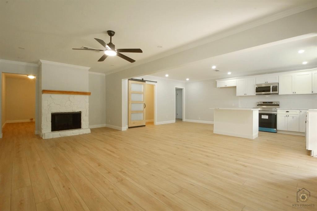 9227 Walker Road Shreveport, LA 71118 - Photo 4 of 16 a view of a kitchen with a sink and a fireplace