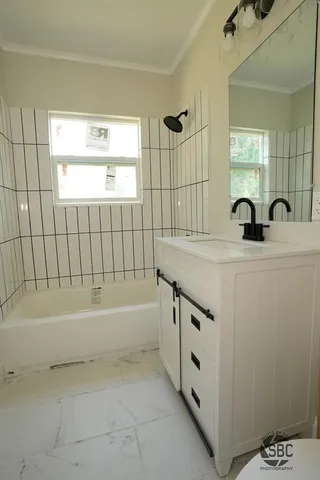 a bathroom with a bathtub and a sink
