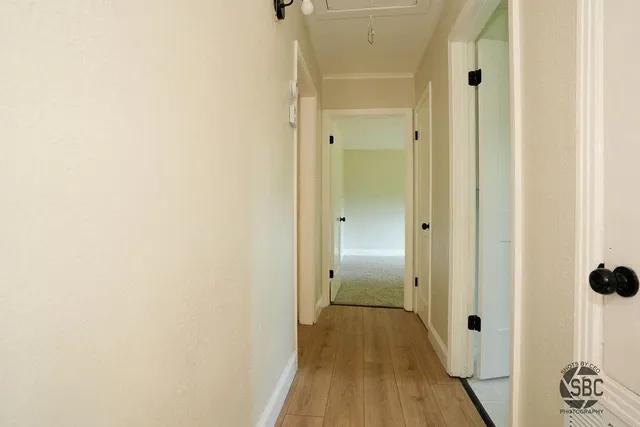 a view of a hallway with wooden floor